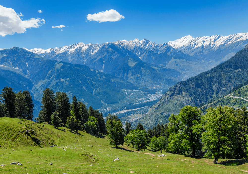Green mountains with snow-capped peaks in Manali