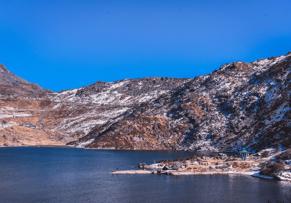 Scenic lake in Darjeeling surrounded by hills and greenery