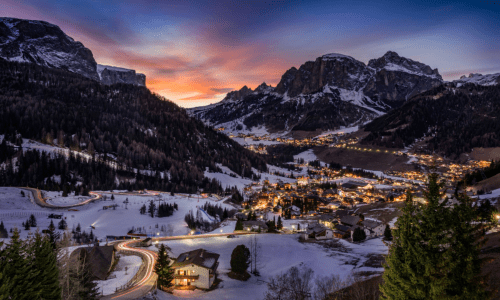 Night view of Manali with glowing lights and mountain backdrop