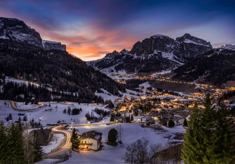 Night view of Manali with glowing lights and mountain backdrop