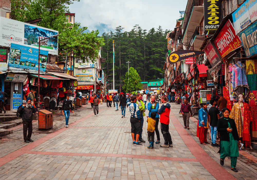 Mall Road in Manali with shops, cafes, and scenic mountain backdrop
