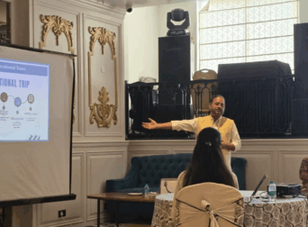 Founder explaining educational tours to school leaders through a presentation